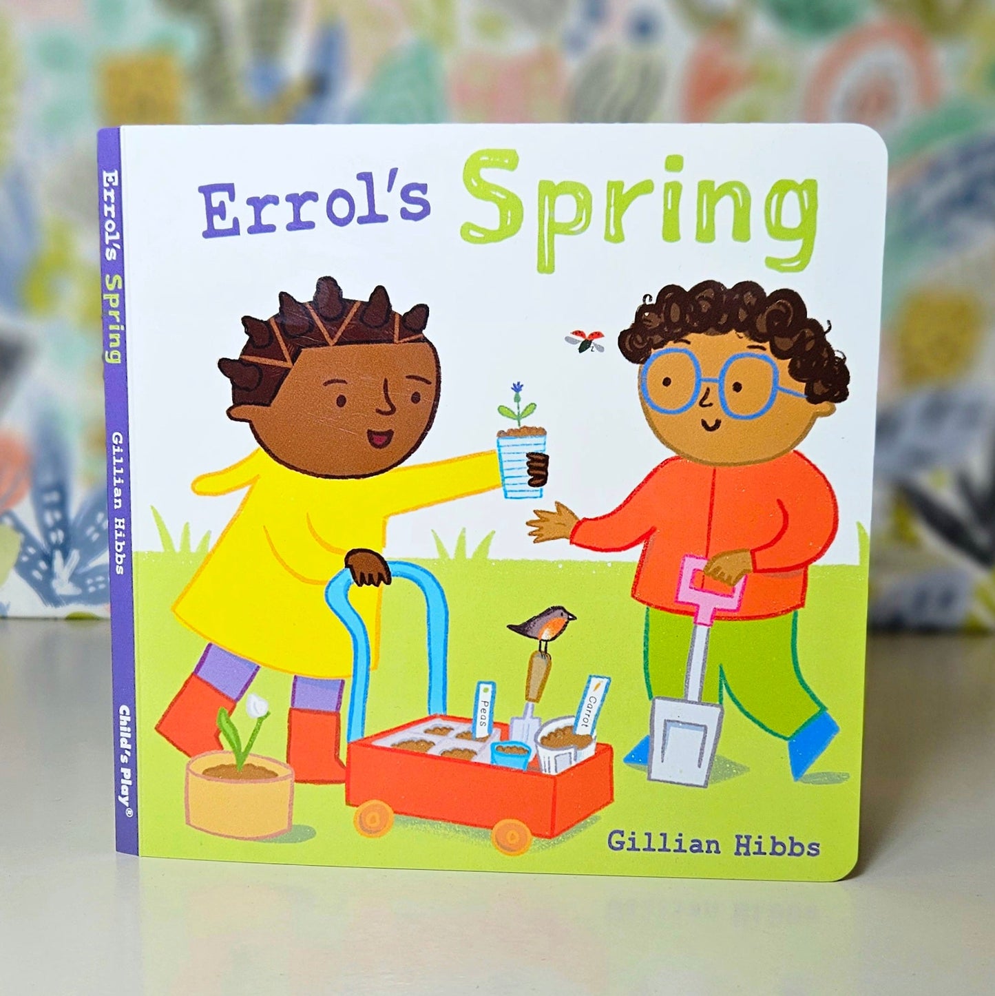 Children's book titled 'Errol's Spring' with colorful illustrations on a floral background.